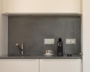 a kitchen with a sink and a coffee maker on a counter at Galini Breeze in Agia Galini