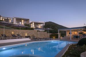 a villa with a swimming pool at night at Galini Breeze in Agia Galini