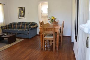 a living room with a table and a couch at Maritsa's Cozy Apartment in Mytilinioí