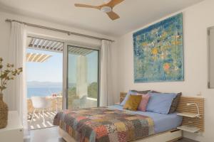 a bedroom with a bed and a view of the ocean at Galini Breeze in Agia Galini +54 photos