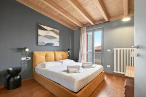 a bedroom with a bed with white sheets and a window at Lulli mansarda- 7Sundays in Milan