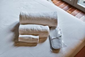 a pair of towels sitting on top of a bed at Lulli mansarda- 7Sundays in Milan +38 photos