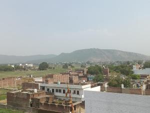 a view of a city with mountains in the background at HOTEL अtithi in Rājgīr