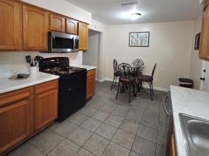 a kitchen with black appliances and a table and chairs at White Door House! in Winter Haven
