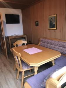 a living room with a wooden table and a couch at Appartement Anja in Fügen