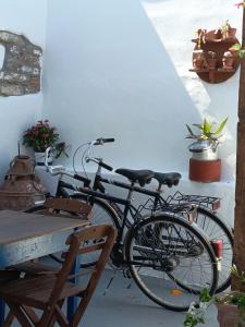 a bike parked next to a table and a table at Grandma Stella's Old House in Apolakkiá