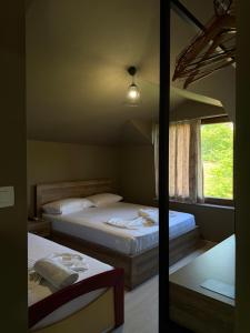 a bedroom with two beds and a mirror at Artist House in Pogradec