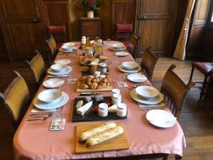 a table with a pink table cloth with food on it at Chateau Morinerie in Villiers