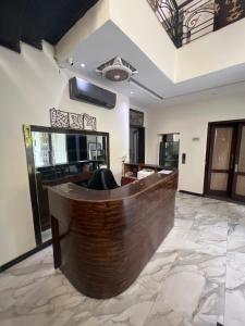 a lobby of a hotel with a reception desk at brick hotel & luxury suites in Lahore