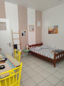 a bedroom with a bed and a table and chairs at Manolia !!! in Kranidi