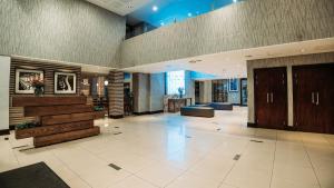 a lobby of a building with a staircase and a lobby at Piazza Hotel Montecasino in Johannesburg