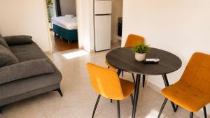 a living room with a table and chairs and a couch at Apartment Nana in Primošten