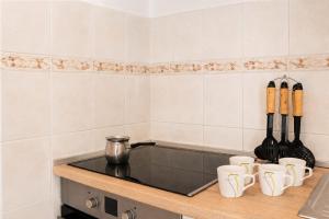 a kitchen with a counter with cups and utensils at Apartment Nana in Primošten +7 photos