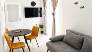 a living room with a couch and a table and chairs at Apartment Nana in Primošten