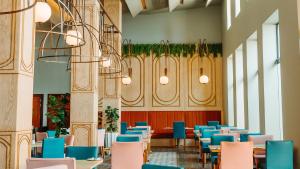 a dining room with blue chairs and tables at Piazza Hotel Montecasino in Johannesburg