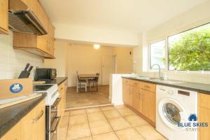a kitchen with a washer and dryer in it at Millfield House by Blue Skies Stays in Middlesbrough