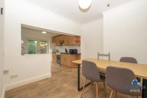 a kitchen and dining room with a wooden table and chairs at Millfield House by Blue Skies Stays in Middlesbrough