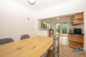 a kitchen and dining room with a wooden table at Millfield House by Blue Skies Stays in Middlesbrough