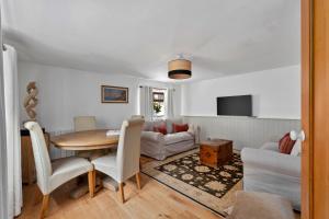 a living room with a table and a couch at Finest Retreats - Poundtree in Wherwell