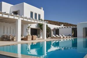 a swimming pool in front of a villa at The Margi Villa Mykonos in Agios Sostis Mykonos