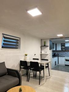 a living room and kitchen with a table and chairs at Kuca za odmor-Tisa Hideaway in Turija +30 photos