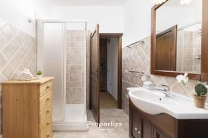 a bathroom with a sink and a shower at Villa Rurale con Vista by Propertize in Monti +56 photos