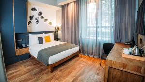 a hotel room with a bed and a desk at Piazza Hotel Montecasino in Johannesburg +22 photos