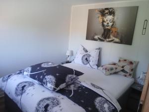 a bedroom with a bed with black and white sheets at U Přejezdu in Česká Lípa