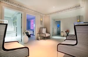 a living room with two chairs and a room at Five Seas by Inwood Hotels in Cannes