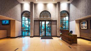 an empty lobby with doors and windows in a building at Piazza Hotel Montecasino in Johannesburg