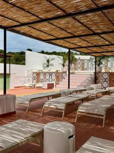 a row of benches sitting on a patio at Hotel Cadaqués1962 by Fimedhotels in Cadaqués