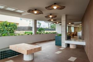 a lobby with a bench and a table at ALEGRIA El Mar & Spa 4 SUP in Santa Susanna