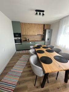 a kitchen with a long wooden table and chairs at Ela’s retreat in Dealu Mare +11 photos