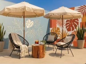 a group of chairs and umbrellas on a patio at Centro Mornings, King & 2BR Suites, Sleeps 2-8, Kitchen WiFi AC, Beach, 5th Ave, ADO & Ferry 4 Min in Playa del Carmen