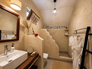 a bathroom with a sink and a toilet and a shower at Juana Ocean Villas in Makunduchi +12 photos
