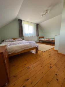 a bedroom with a bed and a wooden floor at Ela’s retreat in Dealu Mare
