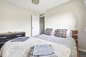 a bedroom with a large bed with two pillows at Saint Johns Rest in Biggleswade +5 photos