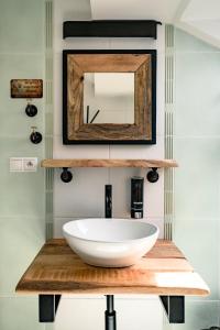 a bathroom with a white sink and a mirror at Maravar - Beer Spa - Adults Only in Liptovský Trnovec +38 photos