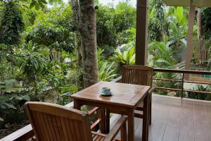 a wooden table and two chairs on a porch at Beach Jungle in Ko Chang