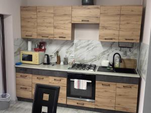 a kitchen with wooden cabinets and a stove at Golden House in Khust