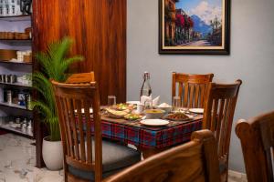 a dining room table with food and a bottle of wine at Hotel Red Rose in Darjeeling