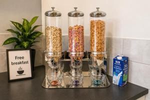 a group of glass containers filled with cereal and glasses at Moderne Appartement in Nuremberg