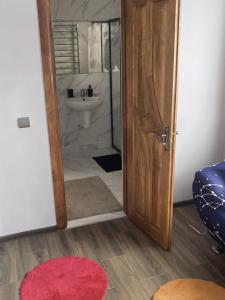 a bathroom with a toilet and a sink and a door at Golden House in Khust +37 photos