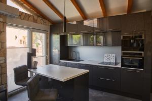 a kitchen with black cabinets and a white counter top at Matteo in Malinska