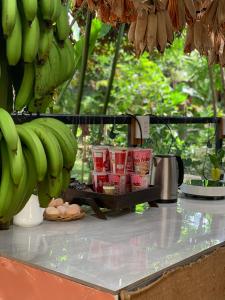 a counter with bunches of bananas and eggs on it at Buon'S garden in Buôn Kao