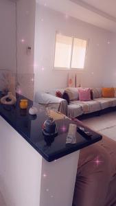 a living room with a couch and a table at appart kelibia a 10 minutes d une belle plage el fatha in Kelibia +2 photos