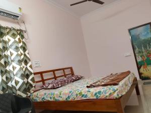 a bedroom with a bed and a ceiling fan at Sagara Darshanam in Vetāpālem +5 photos