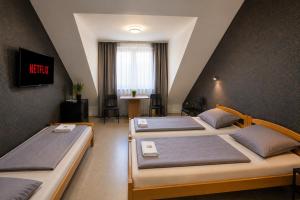 a bedroom with three beds in a attic at Moderne Appartement in Nuremberg