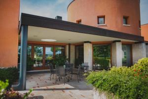 a patio with chairs and a table in front of a building at Hotel Crystal in Preganziol