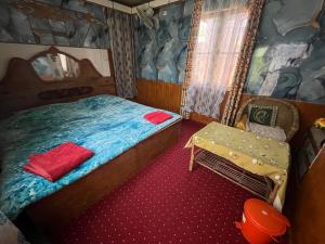 a bedroom with a bed and a chair in it at Hotel sea face in Srinagar